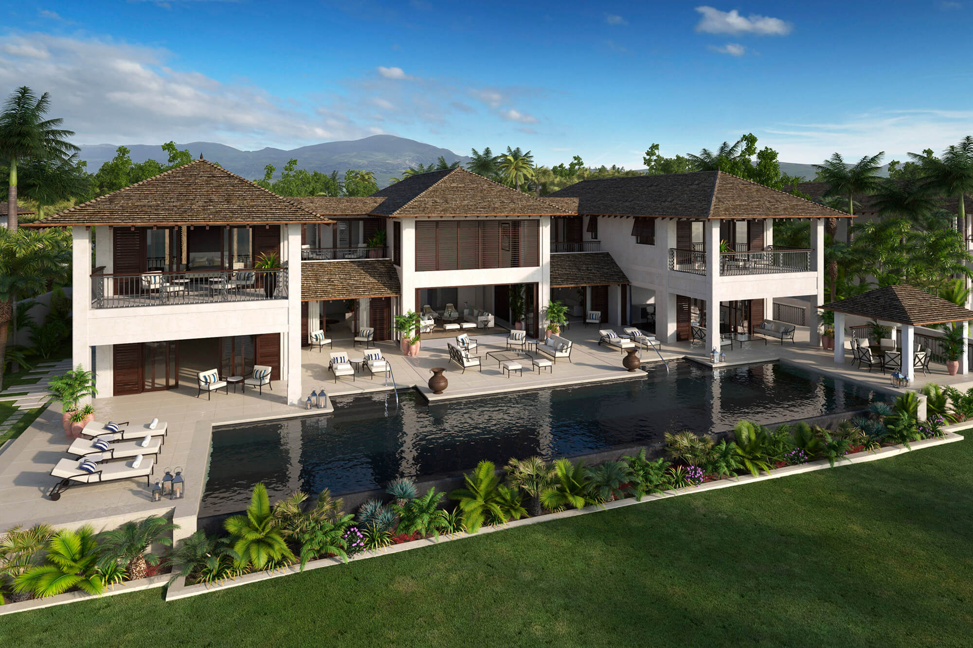 Luxurious modern villa with two stories, featuring large outdoor terraces and a spacious pool. Surrounded by lush greenery and palm trees, it offers scenic mountain views under a clear blue sky.