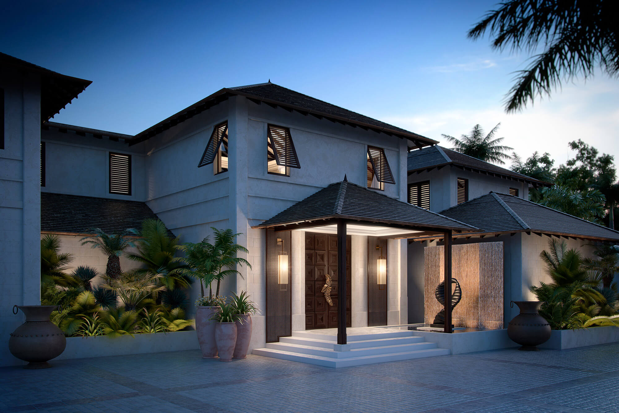 A modern, luxurious villa at dusk, featuring a spacious entrance with a wooden door and stone steps. The exterior is adorned with potted plants, a water feature, and warm lighting, creating an inviting atmosphere. Palms and trees surround the property.